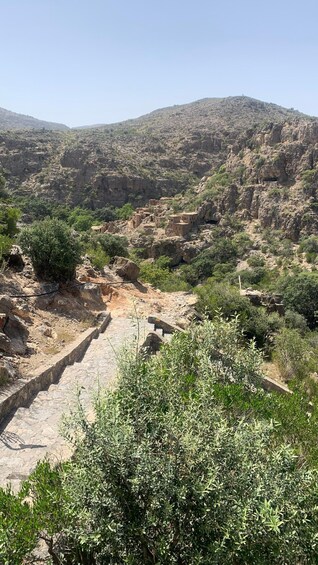 A rocky landscape with ancient ruins and a clear sky. 2
