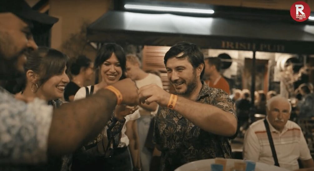 A crowded indoor event with people interacting. 4