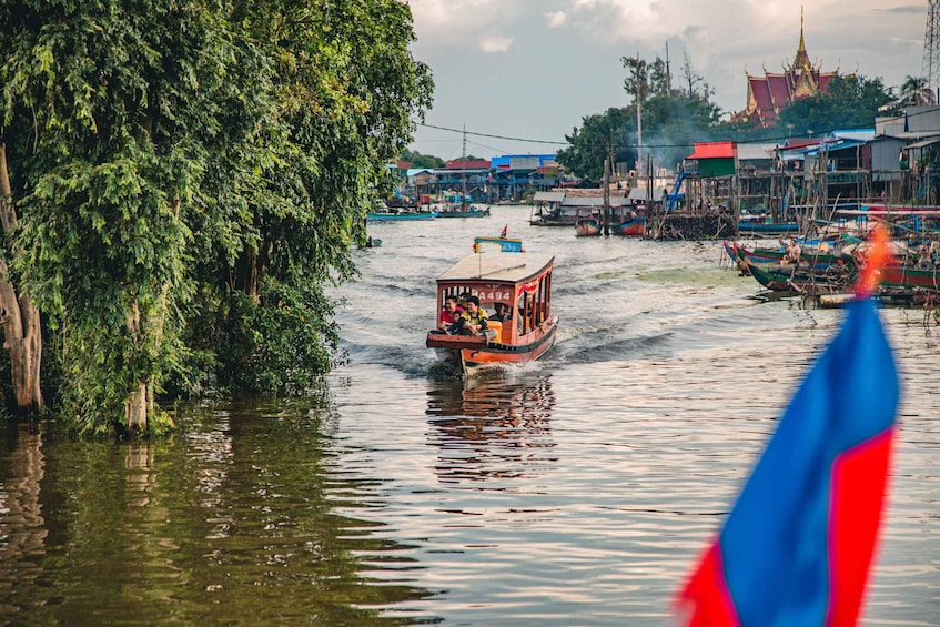 A river with boats, a temple in the background, and a tree on the left. 1