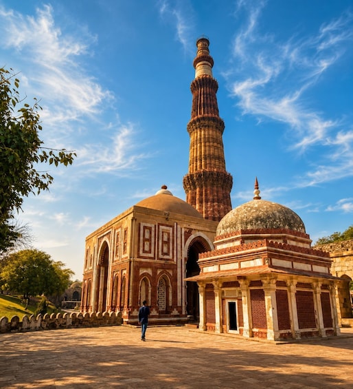 A historic building with a prominent minaret and dome, surrounded by a paved courtyard. 5