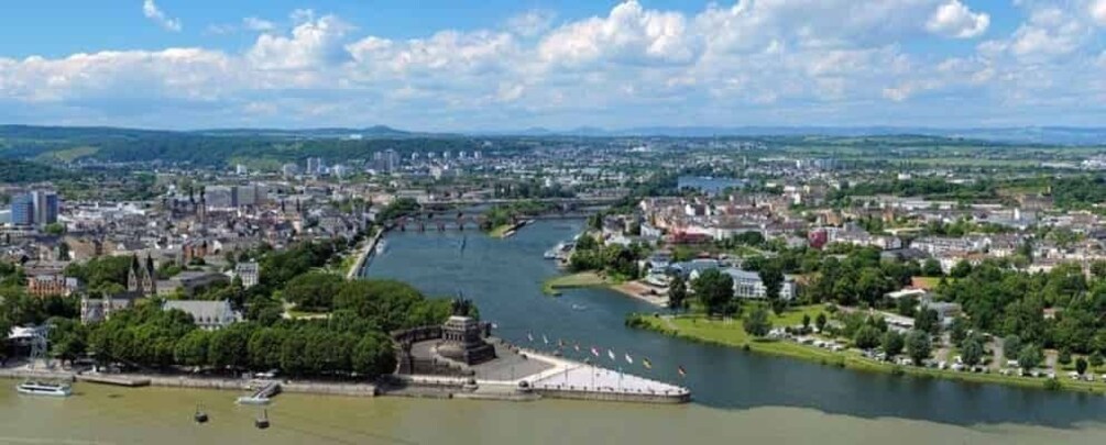 A river flowing through a city with buildings and greenery. 2