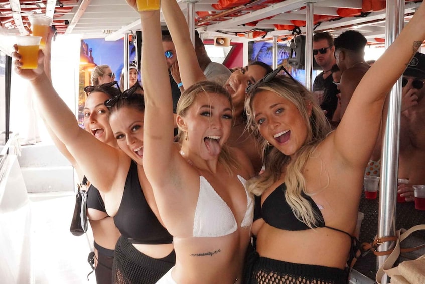 A group of people on a boat, some holding drinks. 1