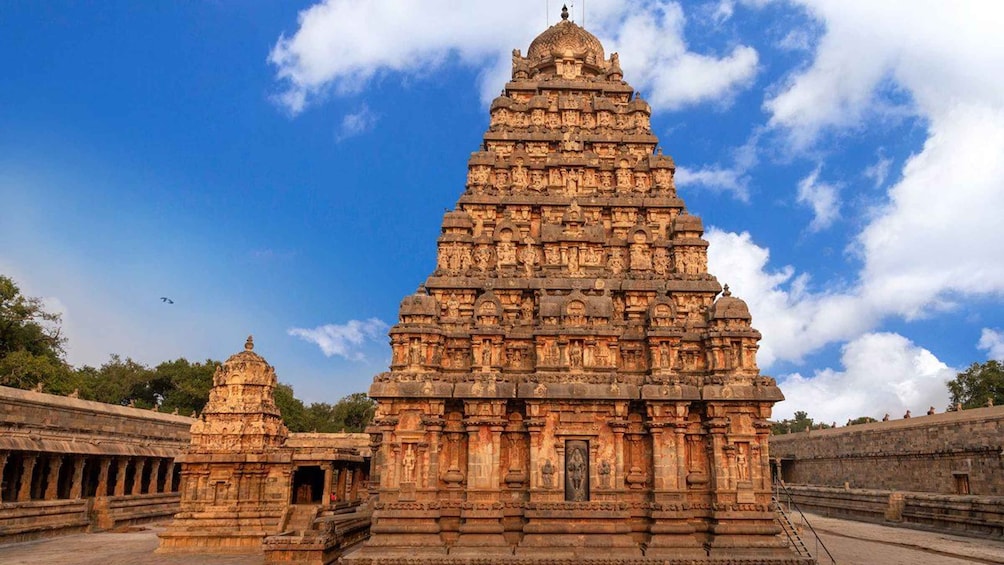 A large temple with intricate carvings and a smaller shrine to the left. 2
