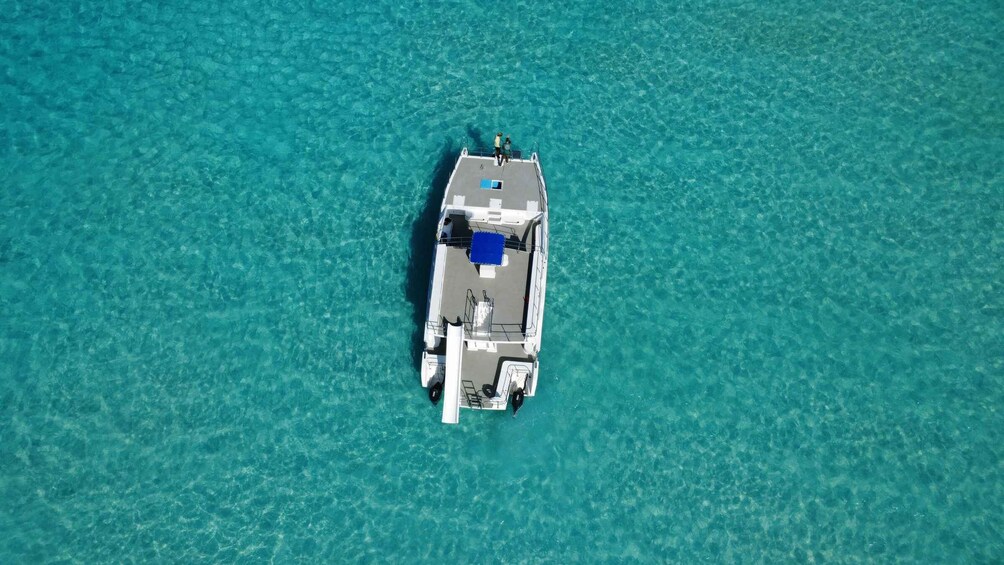 A boat anchored in clear turquoise waters. 3