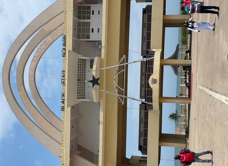 A large open plaza with a prominent star structure in the center, surrounded by buildings with a sign reading "BLACK STAR". 2