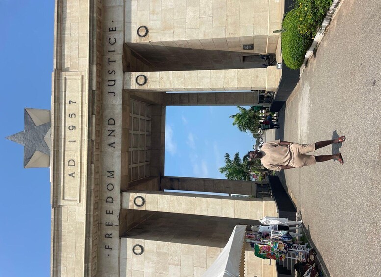 A large stone archway with the inscription "AD 1957 FREEDOM AND JUSTICE" and a star emblem. 1