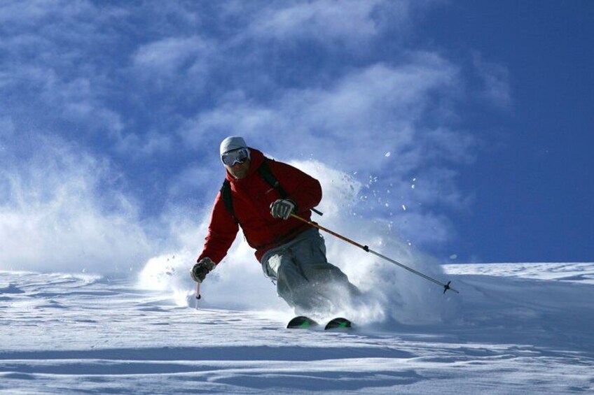 A person skiing down a snowy slope. 1