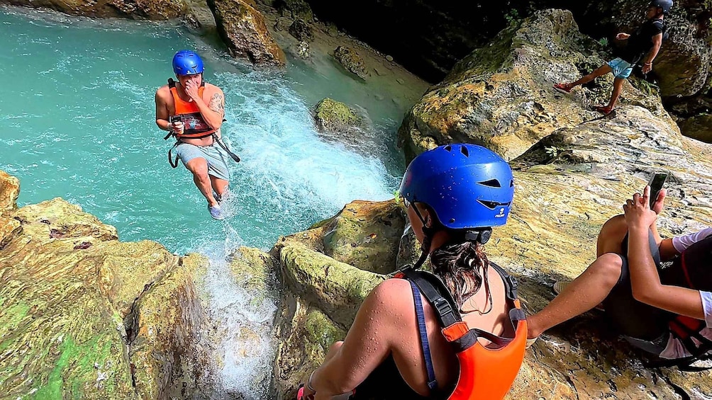 People engaged in white-water rafting in a rocky river. 1