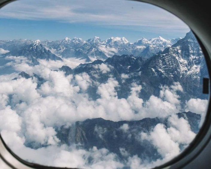 A view of snow-capped mountains from an airplane window. 2