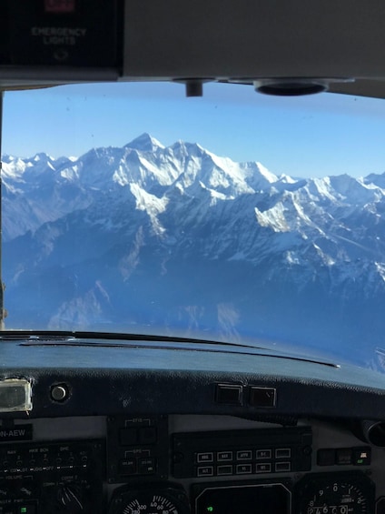 A cockpit view with a mountainous landscape in the background. 4