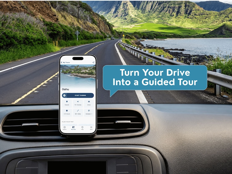 A smartphone mounted on a car dashboard displaying a guided tour app with a scenic coastal road view. 3
