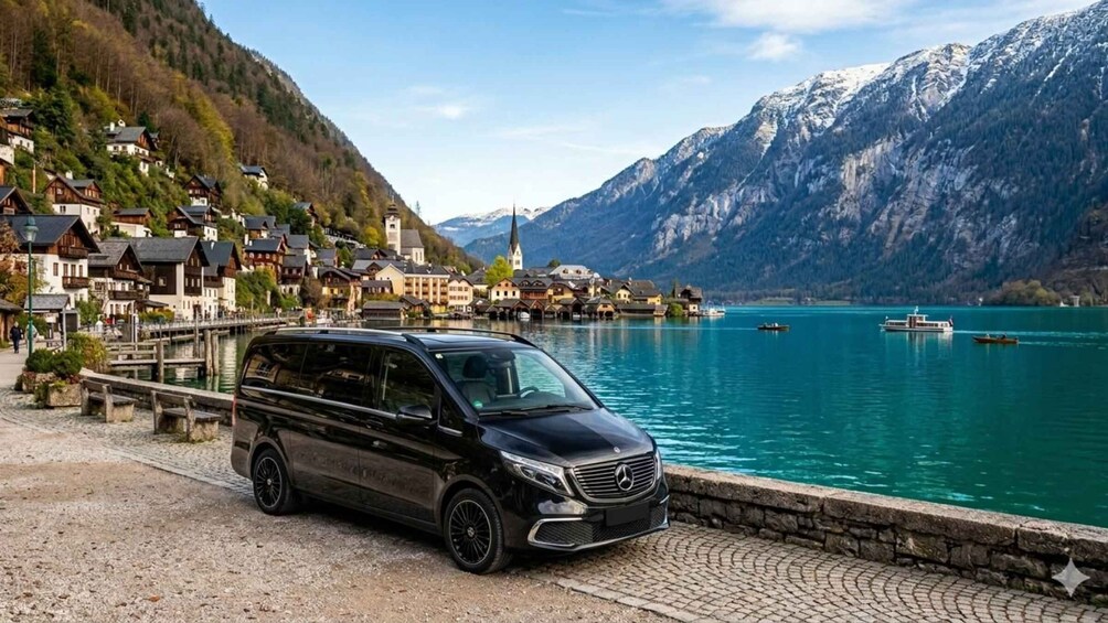 A black Mercedes-Benz minivan parked by a lakeside with a mountain backdrop. 1