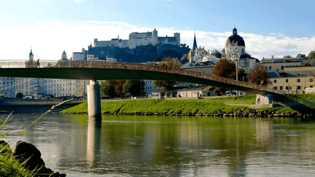 A bridge over a river with a castle in the background. 3