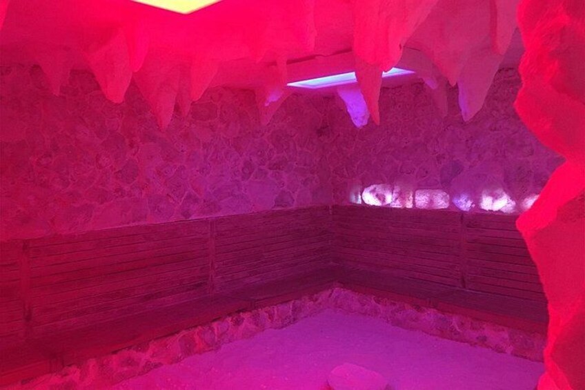An ice cave with wooden benches and red lighting. 2