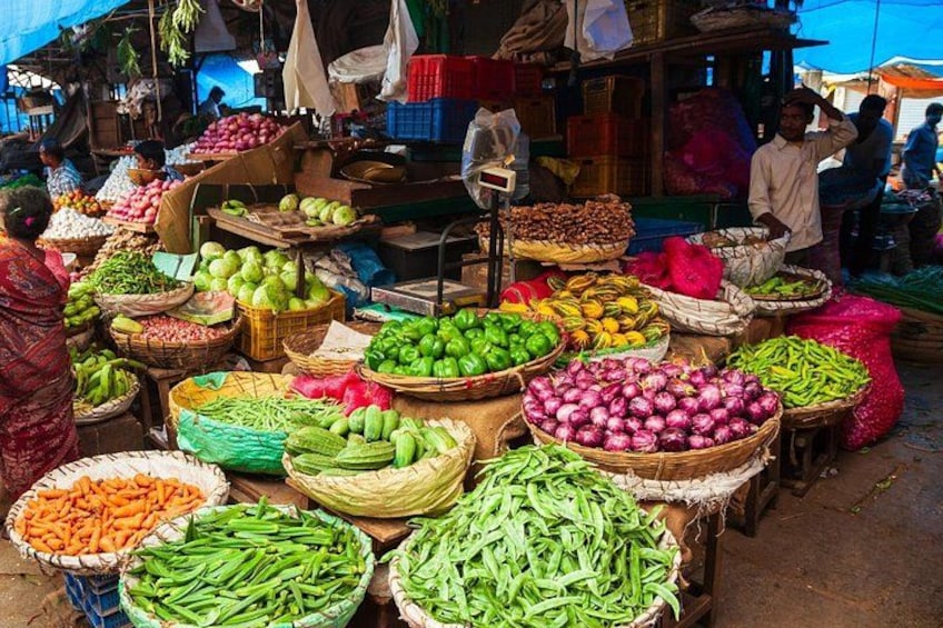 A market with various vegetables displayed in baskets. 3