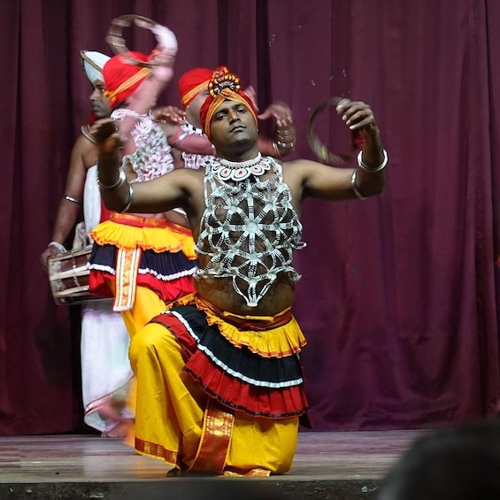 A person in traditional attire performing on stage. 3
