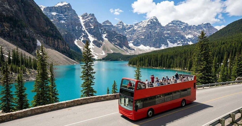 A red double-decker bus on a road with a lake and mountains in the background. 1