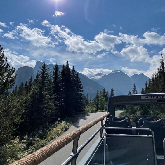 A vehicle on a road with mountains in the background. 5