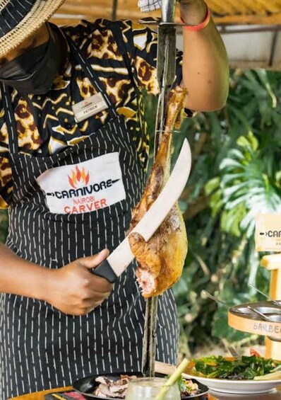 A person carving a roasted chicken with a carving fork. 5
