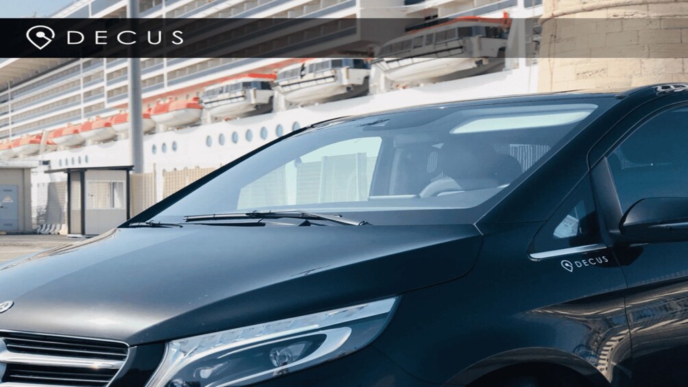 A black SUV with the logo 'DECUS' on the side. 2
