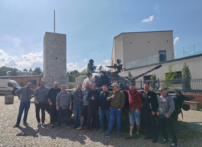 A group of people standing in front of a building and a helicopter. 5