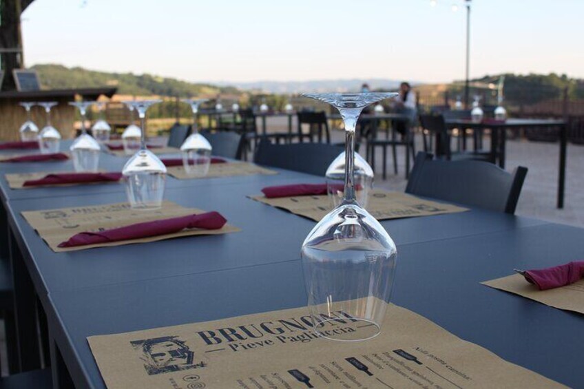 A table set with wine glasses and menus at an outdoor restaurant. 5