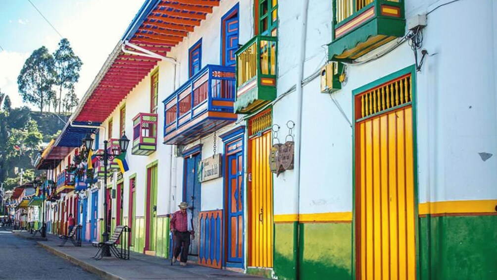 A colorful street with vibrant buildings and a person walking. 5