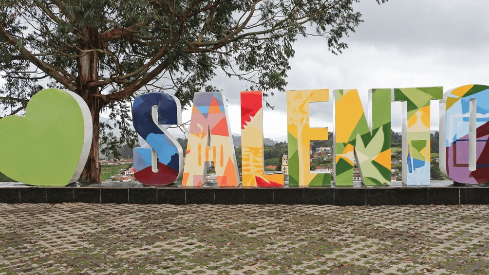 A colorful sign with the word "SALENTO" and a heart-shaped green object. 2