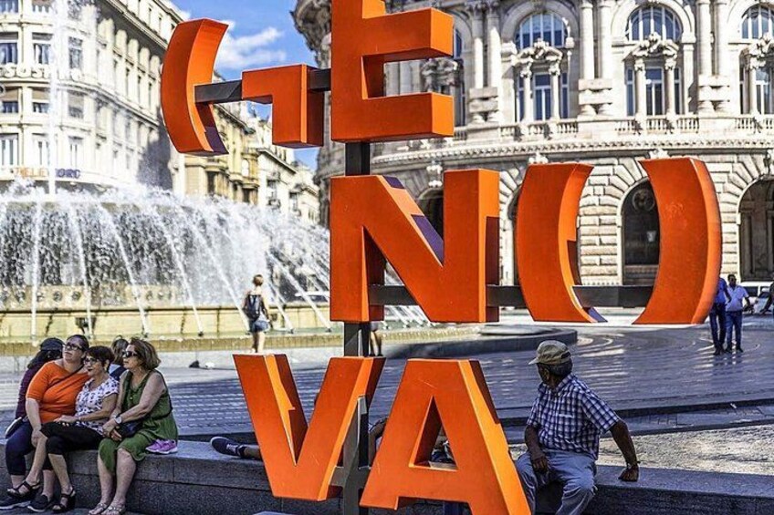 A large outdoor sculpture with the letters 'E', 'N', 'O', 'V', 'A' in orange. 2