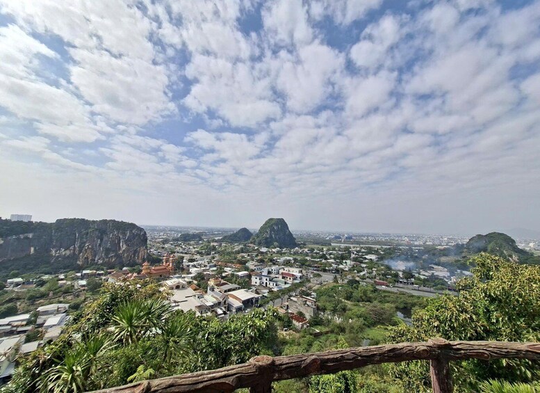 A cityscape with prominent limestone cliffs and a temple. 5