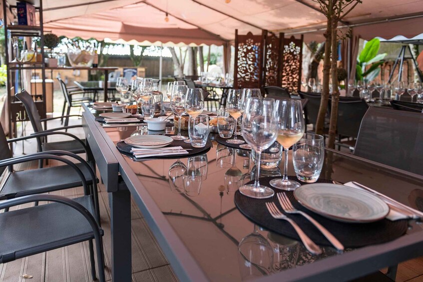 Une table de restaurant dressée avec des assiettes, des couverts et des verres à vin. 2