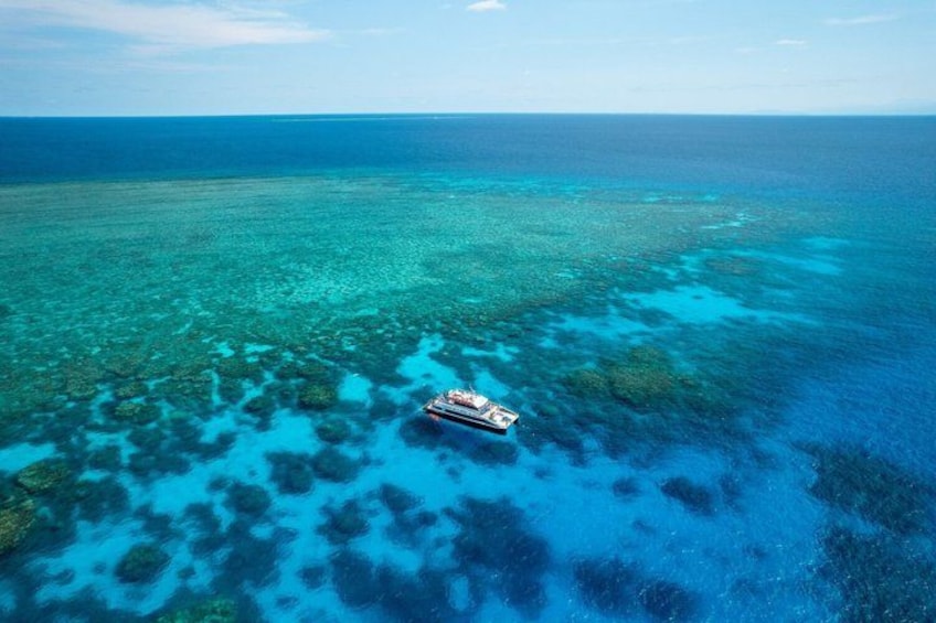 A ship sailing over a vibrant coral reef. 3