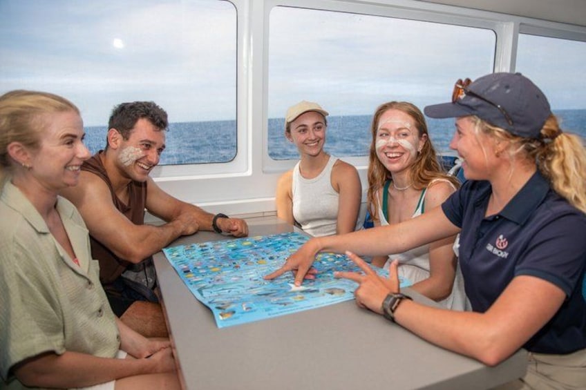 A group of people playing a board game on a ship. 5