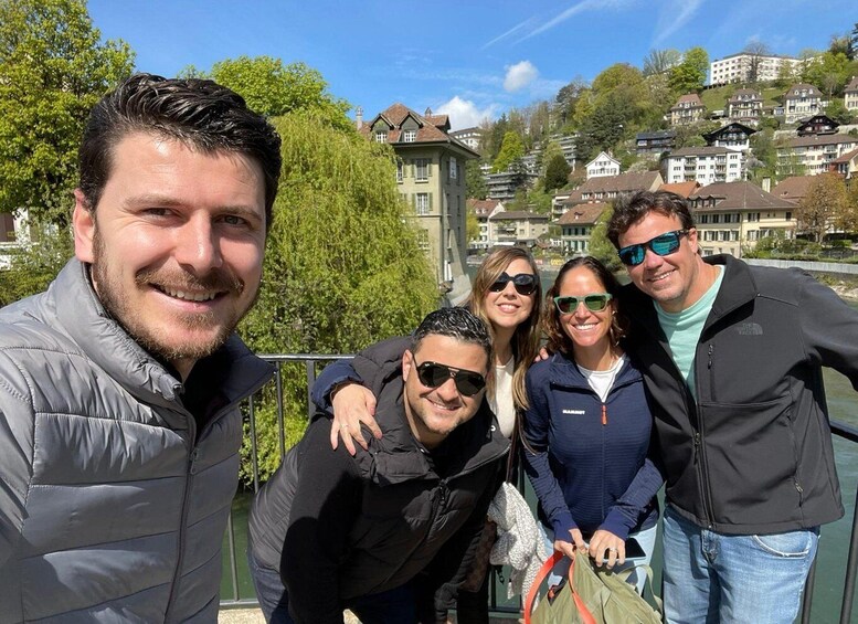 A group of people on a bridge with houses in the background. 5