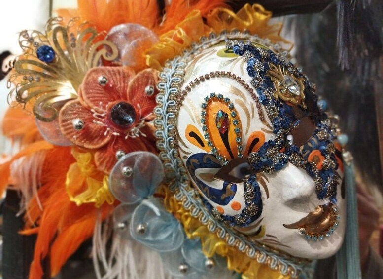 A decorative mask with intricate patterns and colorful embellishments. 1