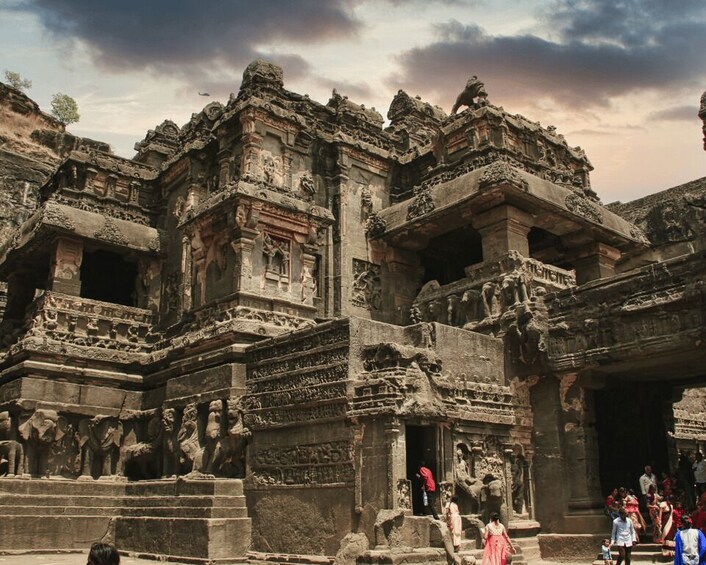 An ancient temple with intricate carvings and multiple statues. 4