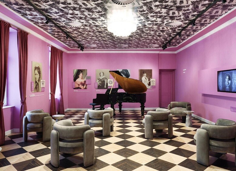 A room with a checkered floor, a grand piano, and posters on the walls. 5