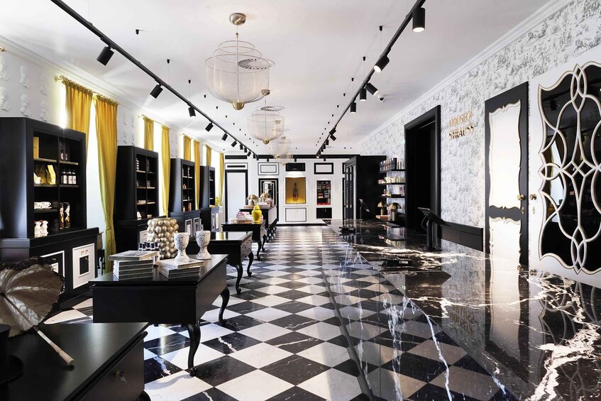 A luxurious interior with a checkered floor, black and white decor, and a central staircase. 3
