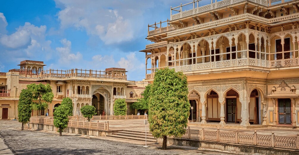 A historic building with intricate architecture and a courtyard with trees. 3
