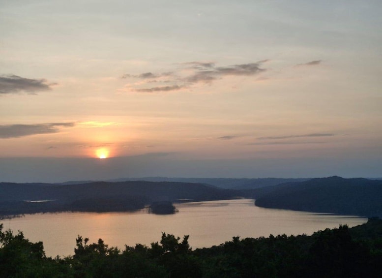 A sunset over a lake with surrounding hills. 5