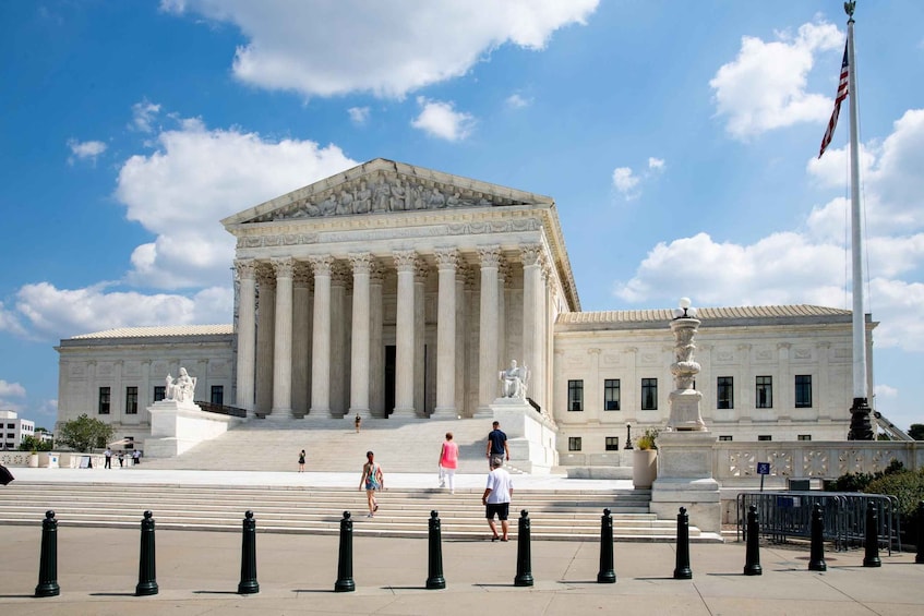 The Supreme Court building with columns and steps leading up to it. 2
