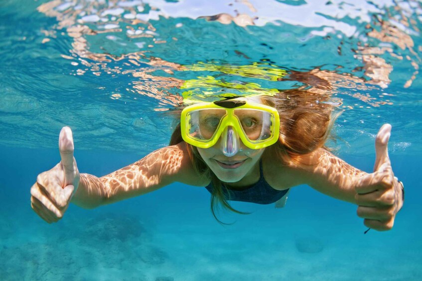 A person underwater giving a thumbs up. 2