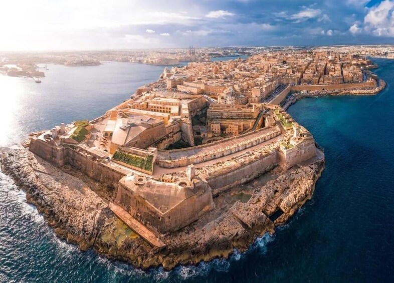 A coastal city with a fortified structure surrounded by water. 2