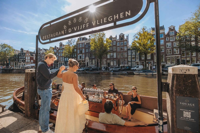 A canal-side restaurant with a view of Amsterdam's architecture. 3