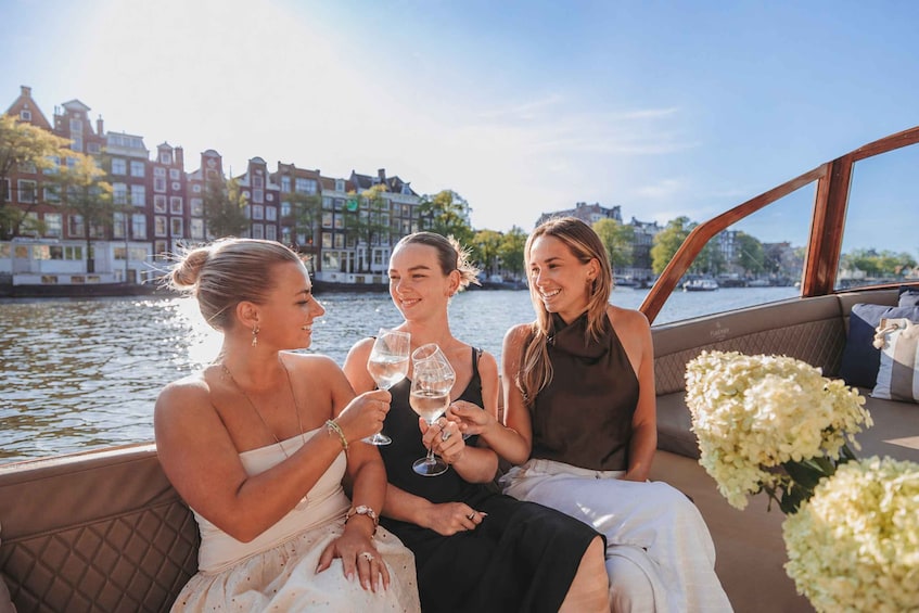 Three people on a boat with a cityscape in the background. 4
