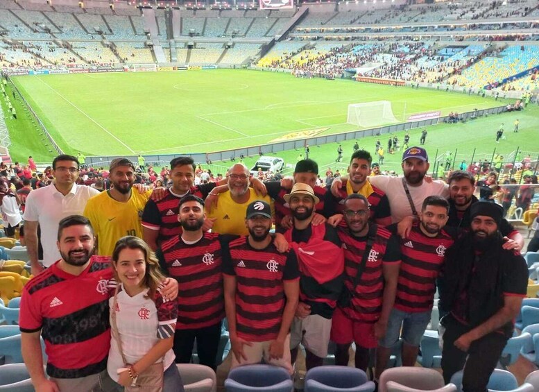 A group of people in a stadium with a soccer field. 4