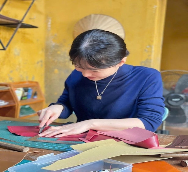 A person working with leather materials at a table. 3