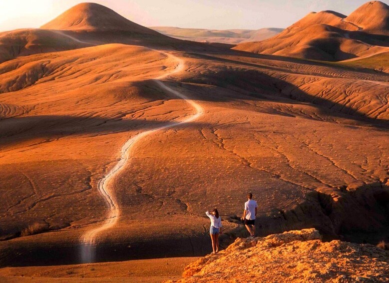 A desert landscape with rolling hills and a winding road. 5