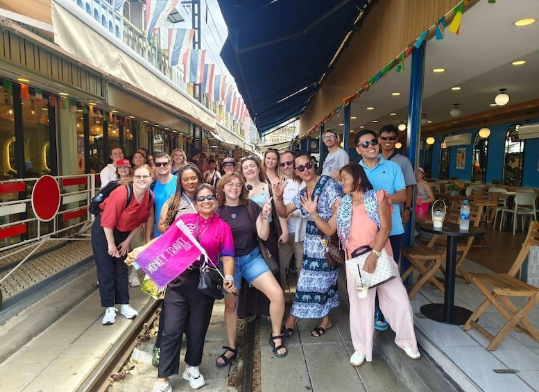A group of people posing on a cruise ship deck with a 'Money Travel' banner. 3