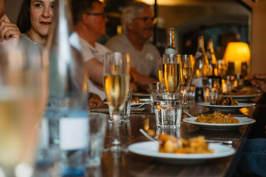 A dining table with glasses of champagne and plates of food. 5